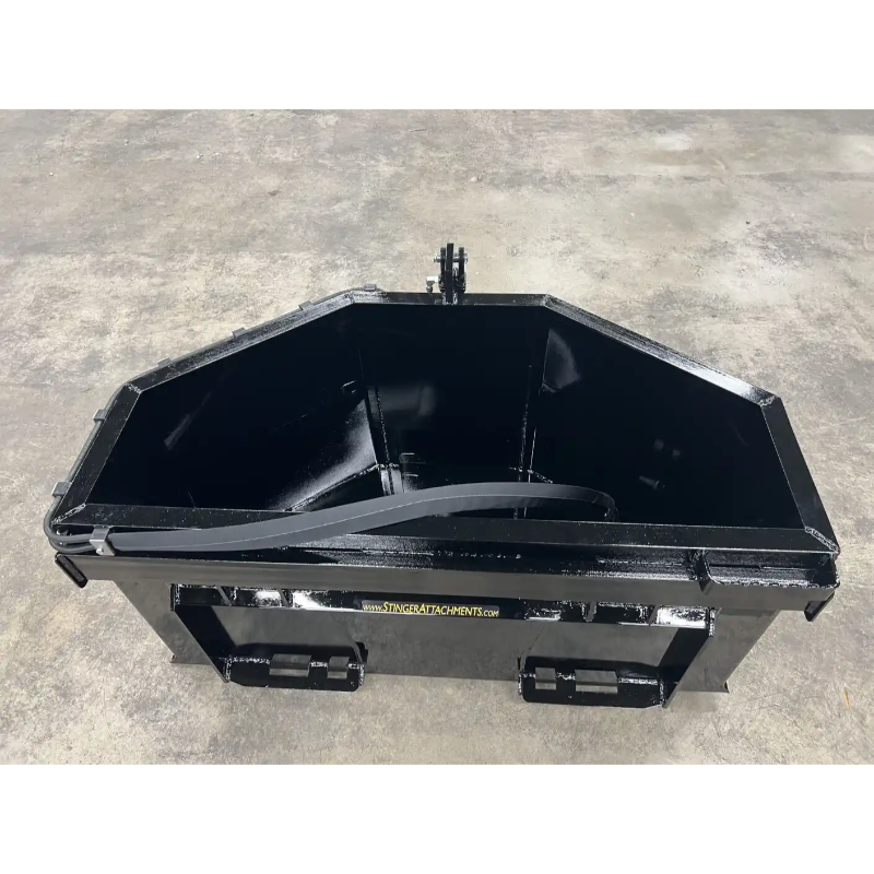 Black steel skid steer concrete bucket attachment with reinforced sides and rear mounting brackets on concrete floor