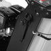 Close-up of gasoline engine, black metal frame, white tank, mounting hardware, and control cable