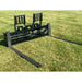 Black steel skid steer pallet fork attachment with flat extended tines and perforated vertical backrest on grass field