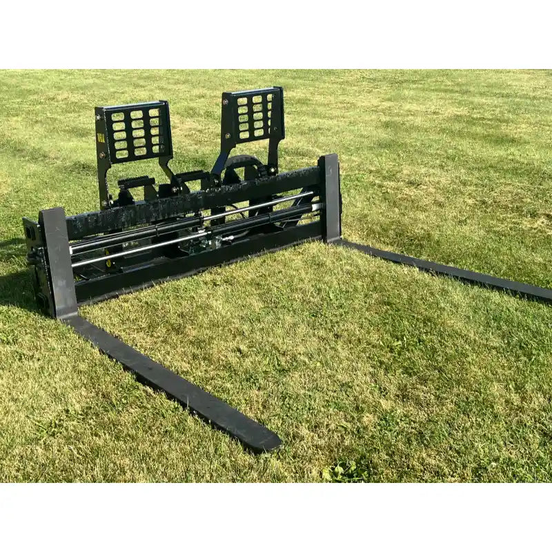 Black steel skid steer pallet fork attachment with flat extended tines and perforated vertical backrest on grass field