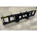 Black steel skid steer attachment frame with multiple mounting points on concrete floor viewed from back left angle