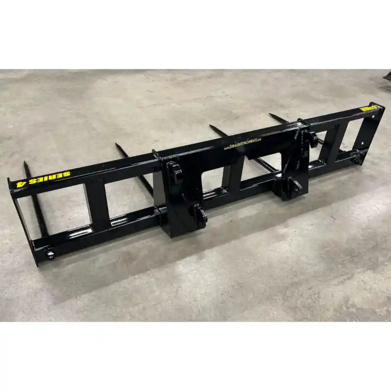 Black skid steer attachment frame with mounting brackets on concrete floor