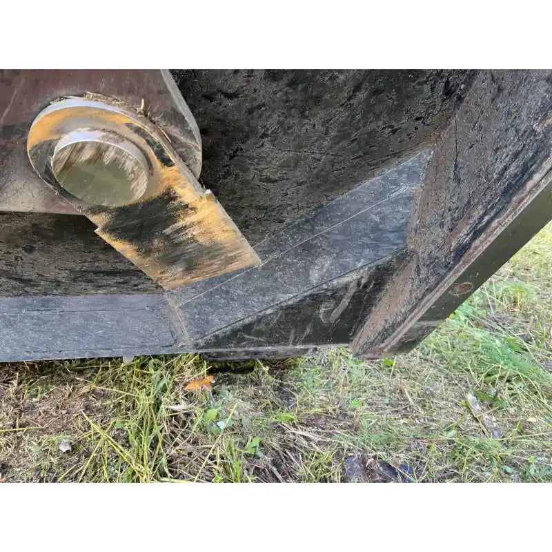 Close-up of a skid steer brush cutter attachment edge showing wear plate and mounting pin, gallery image 20, 800x800 square