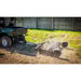 Swisher 48-inch driveway grader attached to ATV, angled side view, clearing dirt and leveling ground, gallery position 1