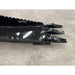 Black metal skid steer attachment bucket with three thick digging teeth and serrated cutting edge on concrete floor