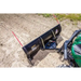 Operator view of black Swisher 62-inch plow rolled blade attached to green utility vehicle, soil surface, gallery 1