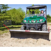 Green utility vehicle with Swisher 62-inch plow rolled blade attached pushing soil, gallery position 1