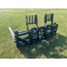 Black skid steer pallet fork attachment with two adjustable vertical backrests and dual flat fork tines on grass field