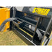 Close-up of black metal step with textured grip and hydraulic hose on yellow loader attachment frame over grass field