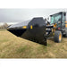 Side view of black steel hydraulic dump bucket attachment mounted on a yellow loader on grassy field