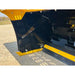 Close-up of black metal skid steer snow pusher foot blade with yellow bolt-on cutting edge on gravel ground