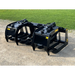 Black steel skid steer root grapple attachment with dual hydraulic arms and curved tines on gravel and grass background