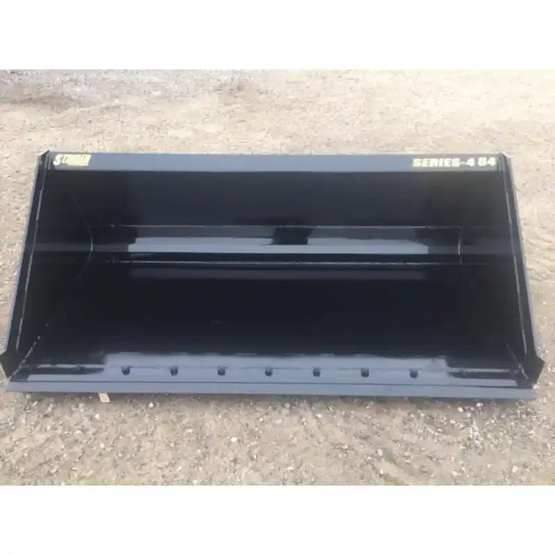 Front view of black skid steer material bucket with reinforced cutting edge and smooth interior resting on dirt surface