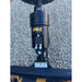 Black hydraulic drive motor with yellow Stinger logo and hydraulic hoses mounted on loader attachment over gravel