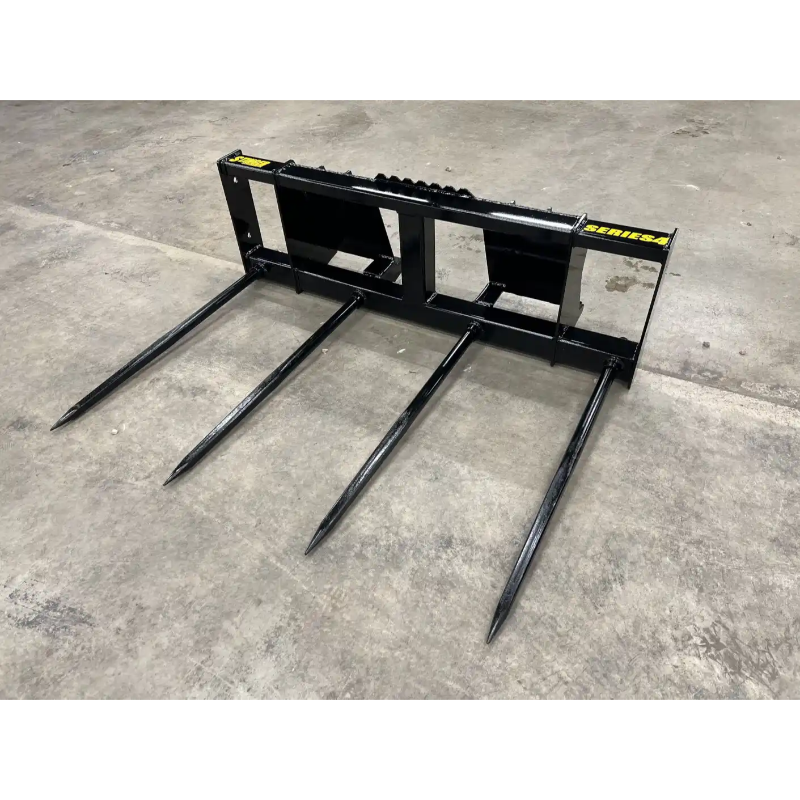 Black steel bale spear skid steer attachment with four long pointed spears on concrete floor viewed from front right angle