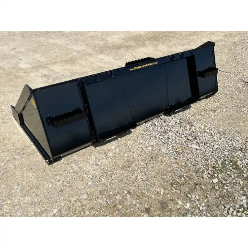 Black steel skid steer material bucket with reinforced side panels and smooth finish resting on gravel surface