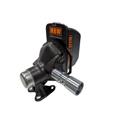 Close-up of black cast iron PTO-driven mechanical attachment with steel shaft and orange MBW branded guard plate
