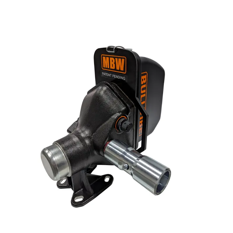 Close-up of black cast iron PTO-driven mechanical attachment with steel shaft and orange MBW branded guard plate