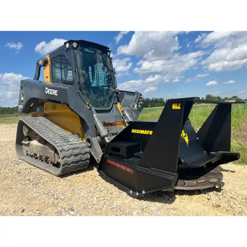 John Deere compact track loader with black disc mulcher attachment on gravel surface under partly cloudy sky