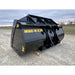 Black steel material bucket attachment with reinforced mounting hooks and yellow model markings on gravel surface outdoors