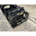 Black skid steer grapple attachment with hydraulic cylinder, solid steel frame, and wide spaced tines on concrete floor