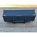 Front view of black steel construction bucket attachment with smooth edges and yellow brand markings on gravel ground