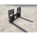 Black steel pallet fork attachment with integrated backrest and weld reinforcements on gravel surface