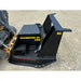 Black skid steer hydraulic mulcher attachment with hoses and safety warning label on gravel surface