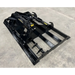 Back left angle view of black steel skid steer land plane attachment with hydraulic components on concrete floor