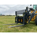 Black steel pallet fork attachment with perforated mesh backrest and two extended fork tines on grassy field