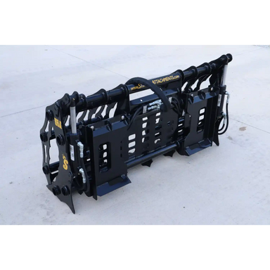 Black steel compact clamp grapple attachment with hydraulic cylinders and mounting brackets on concrete surface outdoors