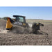 Side view of yellow and black tracked skid steer with rock reel attachment tilling dry soil in open field
