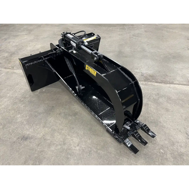 Black metal skid steer stump grapple attachment with three claw teeth and hydraulic cylinder on concrete floor