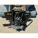 Stump grinder attachment with cutting teeth, hydraulic hoses, and black steel mounting frame on tracked loader platform