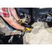 Person wearing gloves attaching Swisher 62-inch plow rolled blade mount to utility vehicle in gallery position 1
