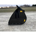 Side view of black steel skid steer bucket attachment with integrated chute and "Made in USA" label on gravel surface