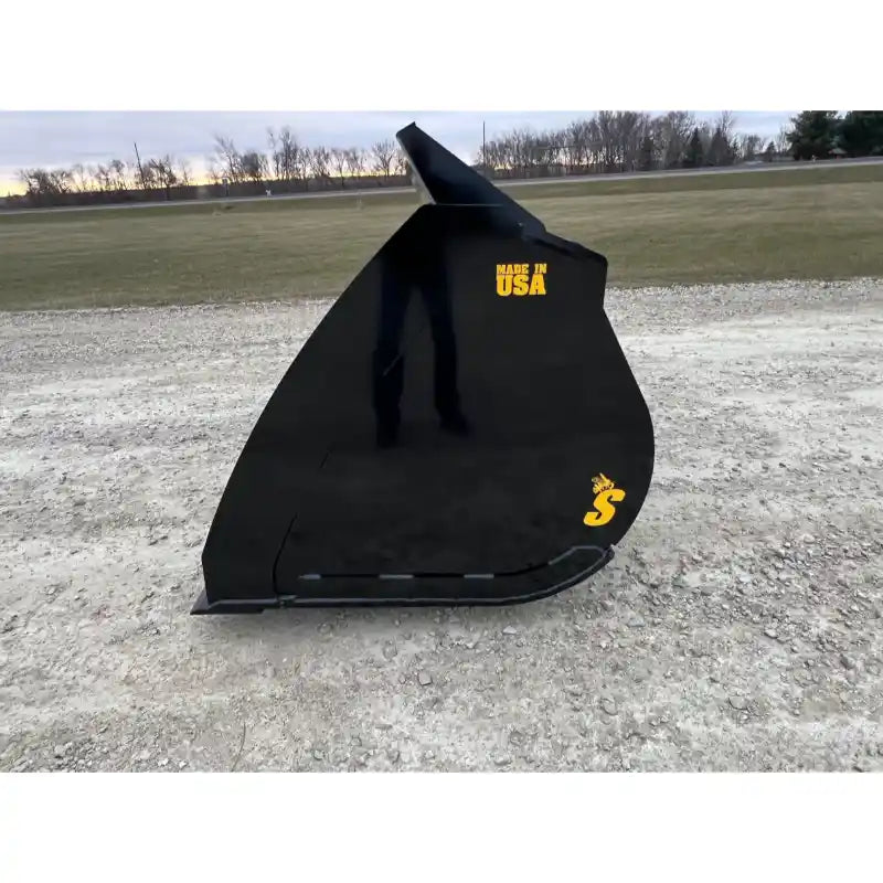 Side view of black steel skid steer bucket attachment with integrated chute and "Made in USA" label on gravel surface