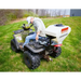 Green ATV with white Swisher spreader mounted on rear rack and operator adjusting controls, gallery position 1