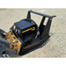 Black steel disc mulcher attachment with hydraulic hoses mounted on skid steer loader on gravel surface