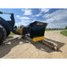 Black steel skid steer snow pusher attachment with yellow bolt-on cutting edge on gravel driveway under blue sky