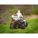 Rear view of Swisher ATV Commercial Pro Spreader mounted on ATV dispersing material across grassy area, gallery position 1