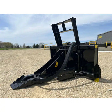 Black steel tree pulling attachment with curved arms and reinforced base resting on gravel surface outdoors