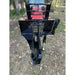 Black steel tree puller attachment with hydraulic arm and curved side plates mounted on red tractor outdoors on grass with leaves