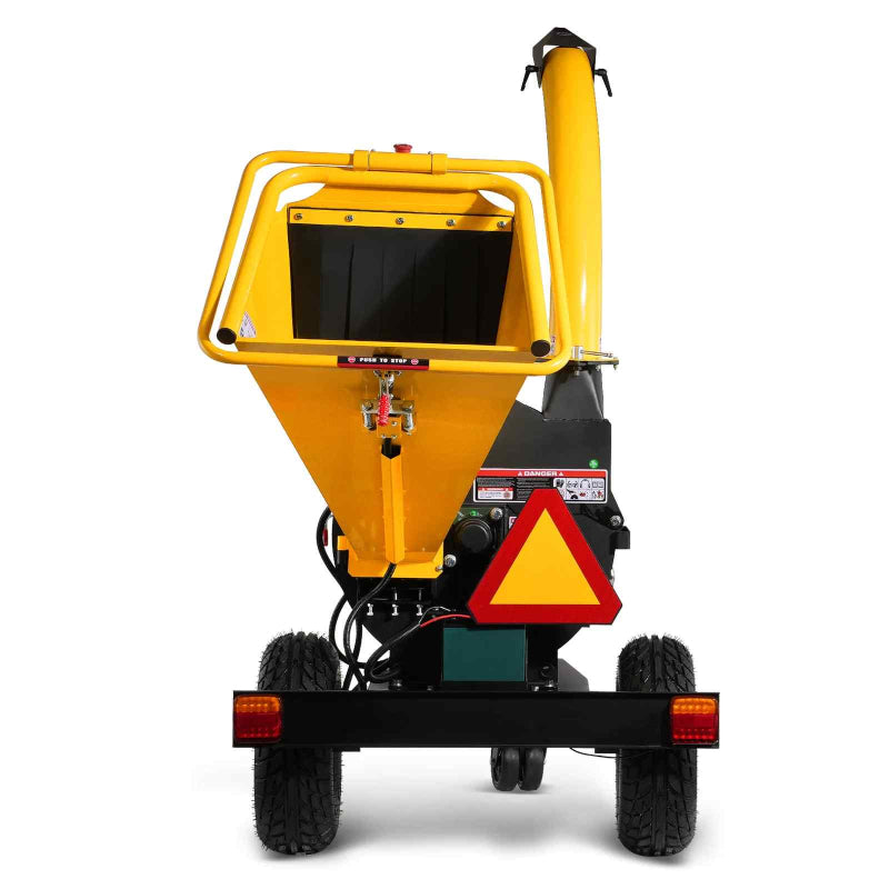 Rear view of yellow MechMaxx 5 inch disc wood chipper with tow bar, safety triangle, and rotating discharge chute gallery position 1