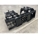 Black steel skid steer root and rock grapple attachment with hydraulic cylinders, reinforced frame, and grid tines on concrete floor