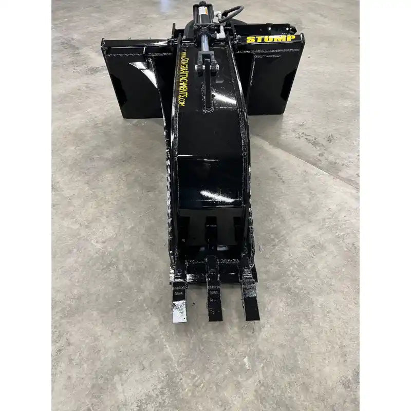 Black steel stump bucket attachment with hydraulic grapple and reinforced mounting brackets on concrete floor