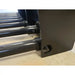 Close-up of black coated steel tubular tines welded to a solid rectangular frame with bolt fasteners on concrete floor