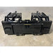 Black metal grapple bucket attachment with dual hydraulic cylinders and mounting brackets on indoor concrete floor