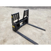 Black steel pallet fork attachment with two long horizontal tines and perforated vertical backrest on dirt ground