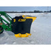Black and yellow steel snow pusher attachment mounted on green compact loader clearing snow on rural snowy field